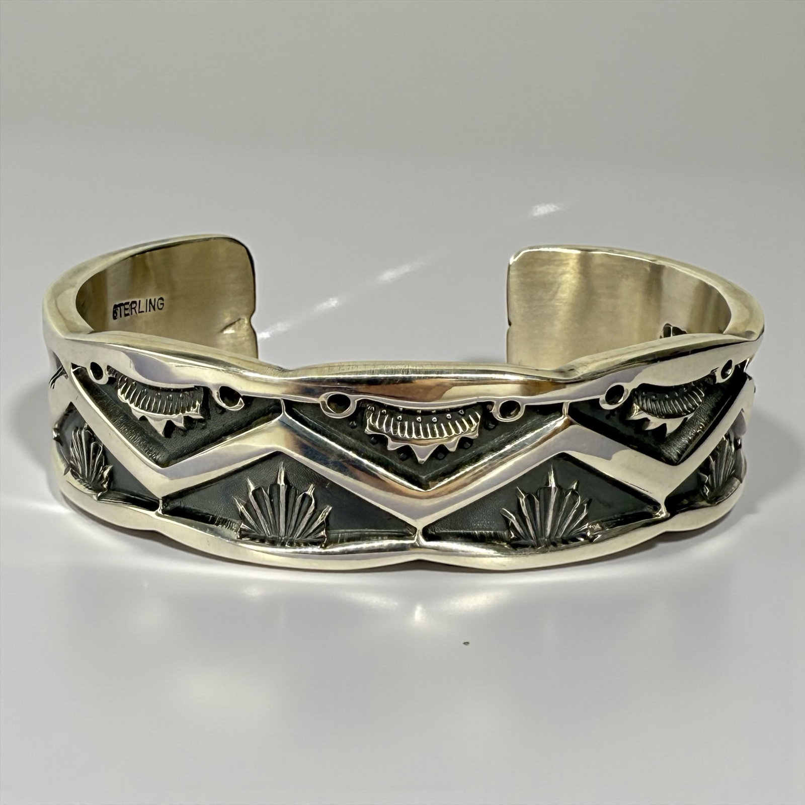 J. Tahe Sterling Silver Hand-Stamped Cuff Bracelet: Bracelet measures 6" with a 3/4" opening. Weight: 87.7g Condition: Very good 