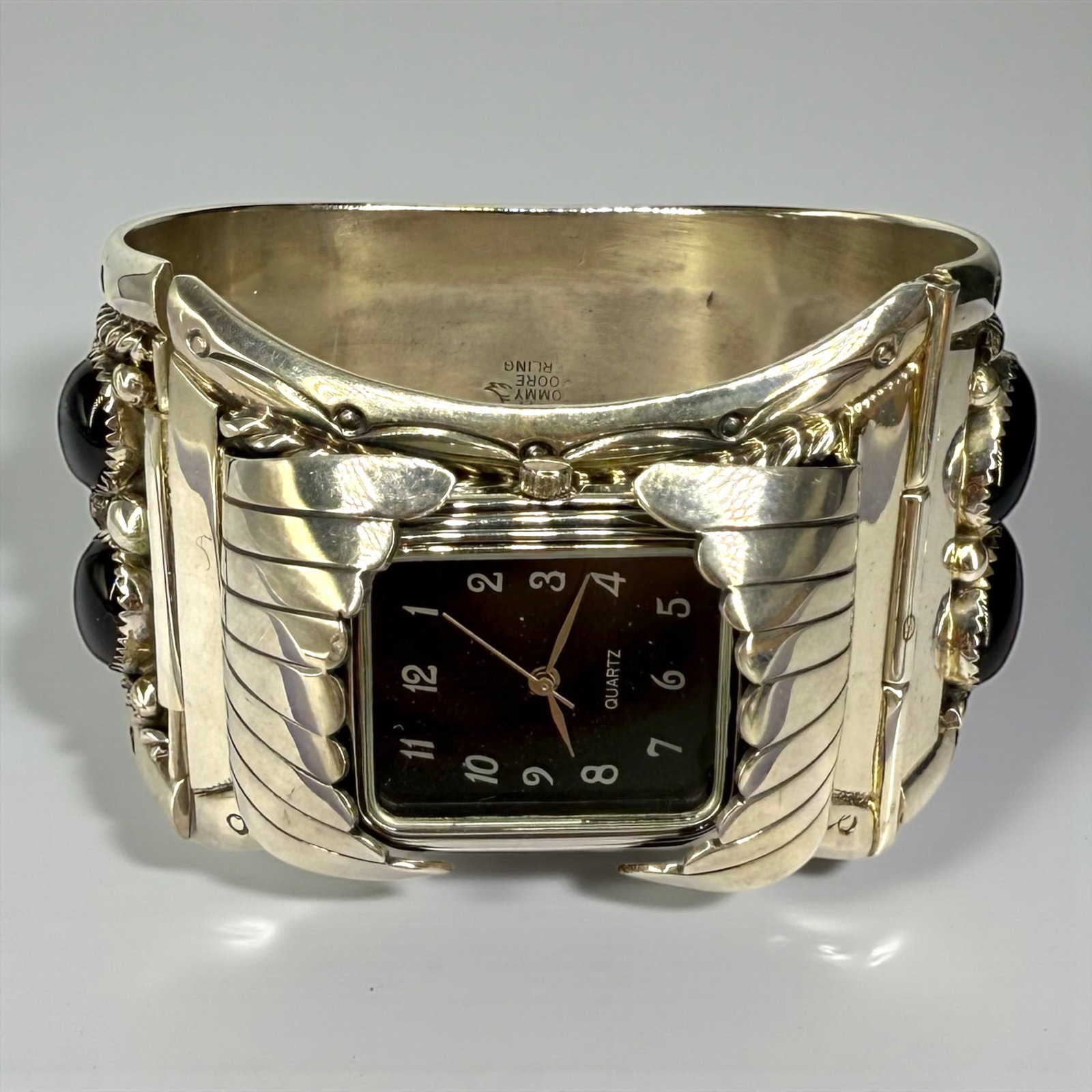 Tommy Moore Sterling Silver & Black Onyx Watch: Onyx cabochons measure approximately 14mm x 10mm Cuff measures 7" and is 1 3/4" wide Weight: 149g Condition: Very Good; watch requ