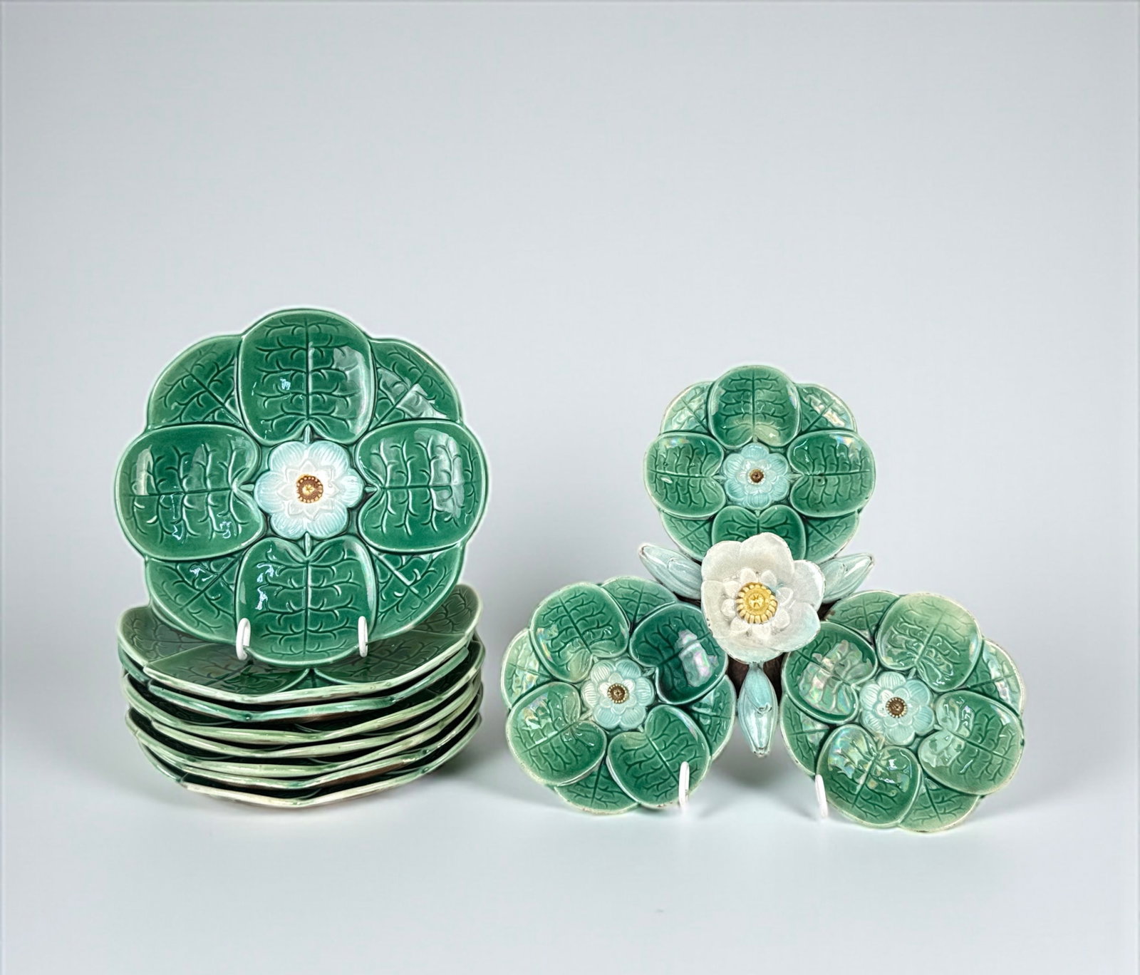 (8) Majolica Water Lily Plates & Platter: Plates: 8” Plater: 3"H x 11"L Condition: Very good overall with minor wear consistent with age and use.