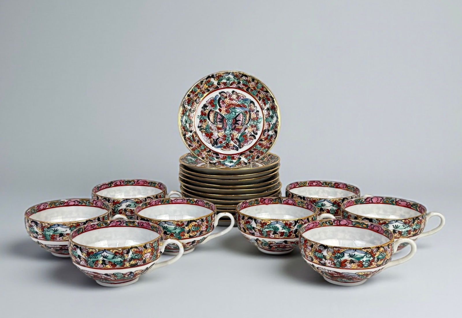 (19pc) ACF Japanese Porcelain Cups & Saucers: Includes (11) saucers and (8) tea cups. Each piece is hand-painted with famille rose floral decoration and gilt accents. Cups: 2" x 3 3/4"