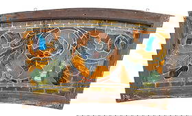 Curved Stained Glass Window With Red & Purple Floral Design: Dimensions: 21 1/4"T x 39 1/2"W x 1 3/4"D Condition: Surface wear and minor scratches to the wood frame. Areas of finish loss and light residue on the glass. A few panels have sm