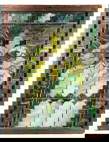 Stained Glass Window With Green & Blue Fleur-de-Lis Design: Dimensions: 41 1/4"T x 31 3/4"W x 1 3/4"D Condition: Surface wear and minor scratches to the wood frame. Areas of finish loss and light residue on the glass. A few panels have sm