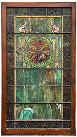 Leaded Stained Glass Window With Green & Pink Torch Motif: Dimensions: 57"T x 31 7/8"W x 1 3/8"D Surface wear and scratches to the frame. Minor finish loss and scattered areas of residue on the glass. A few light hairline cracks in