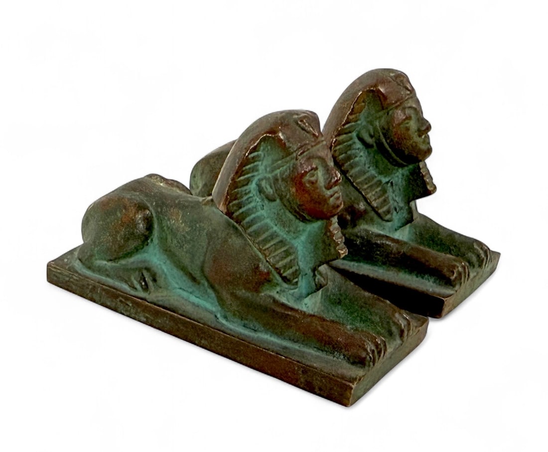Pair of Tiffany Studios "Sphinx" Paperweights: Signed: Tiffany Studios, New York Numbered: 931 Dimensions: 1 1/2"T x 2 5/8"L Condition: Light patina consistent with age, otherwise in good condition.