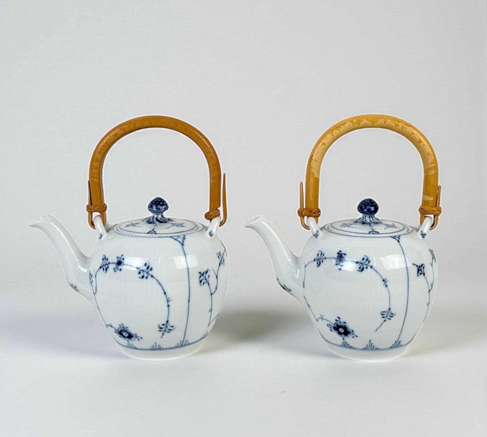 Pair Of Royal Copenhagen Blue Fluted Tea Pots: Bamboo handles. Height: 8" (includes handle) Condition: Very good with minimal wear, no chips or cracks. 