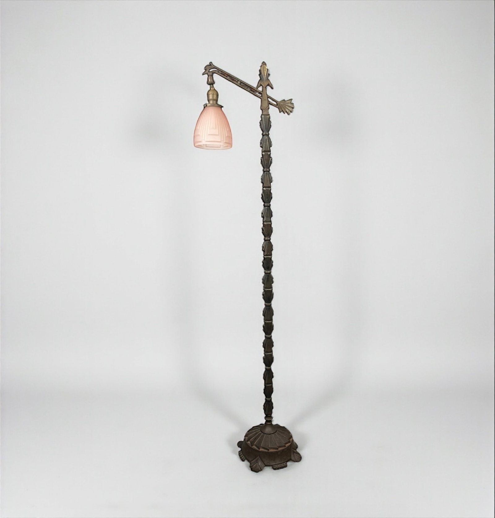 Art Deco Iron Floor Lamp With Frosted Pink Glass Shade: Height: 58" Condition: Good. The lamp lights up. Surface wear and oxidation to the metal are consistent with age. The glass shade is intact with no chips or cracks.