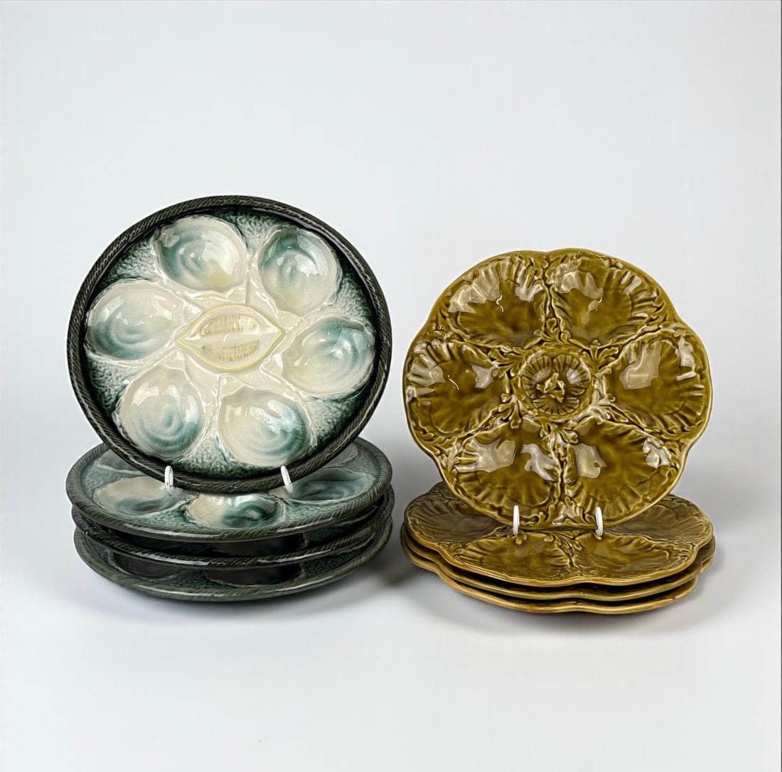 2 Sets Of French Oyster Plates: (4) Plates in each set. Diameter: 9 3/4" Condition: Some crazing seen to one of the green plates. One mustard-colored plate has a small rim chip. All others are in good condition.