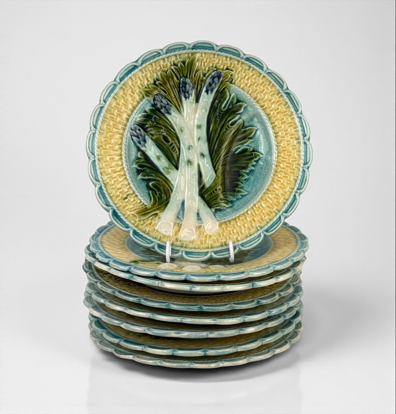 (8pc) Majolica Asparagus Plates: Diameter: 9 1/4" Condition: One plate has a very small area of missing glaze on the backside.. All others are in good condition.