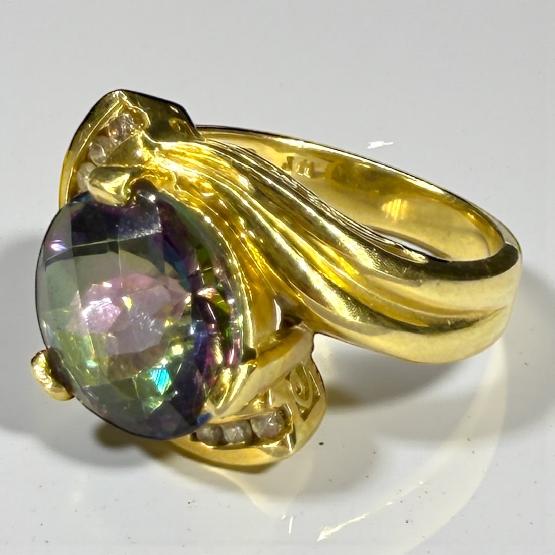 Ladies Mystic Topaz & 14k Gold Ring: Size: 7 3/4, topaz approx. 11.7 mm diameter Weight: 9.5g Condition: The ring has light surface scratches consistent with wear and use. 