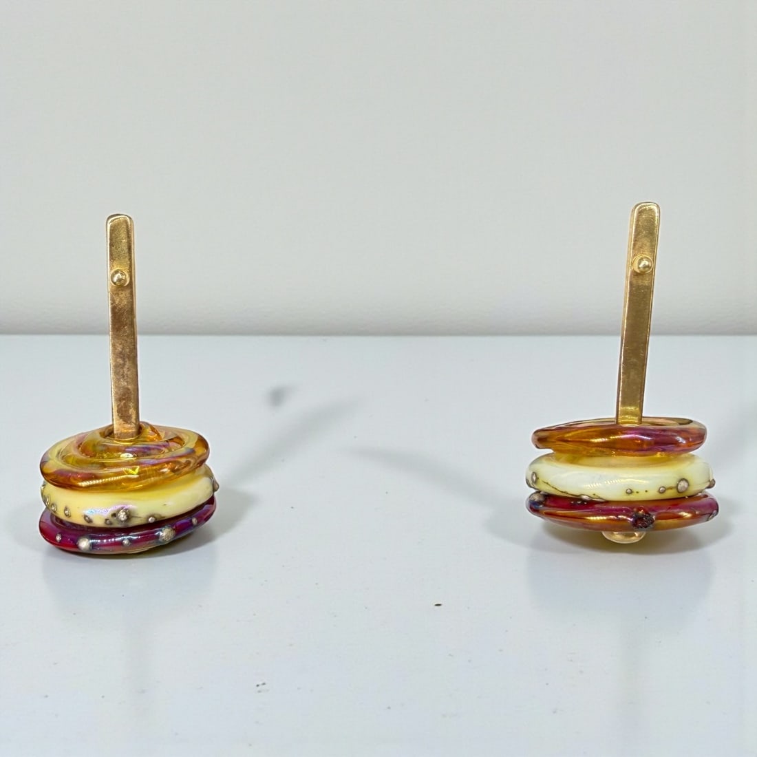 Pair of 14K Gold Drop Art Glass Earrings: Dimensions: 1 1/4" Long Weight: 11.5g (including glass) Condition: The earrings are in good condition with light surface wear to the gold, consistent with use. 