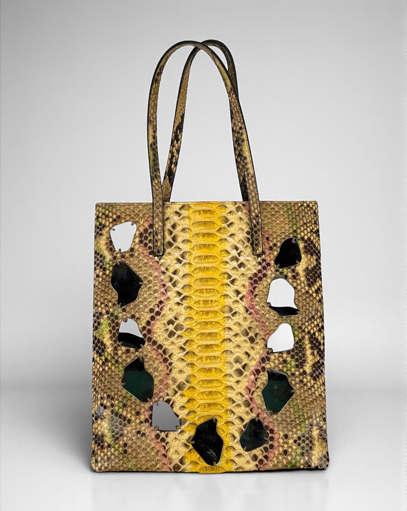 Fendi 1960's Vintage Purse: The purse is made of python with mirror embellishments. Dimensions: 10 1/2" T x 9" W Condition: The purse is in good vintage condition with wear to the exterior and