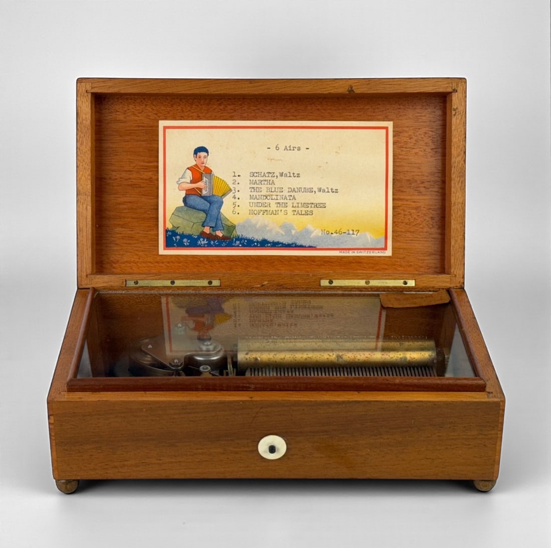 Reuge Sainte Croix Music Box: Dimensions: 3" T x 8 3/4" W x 4 3/4" D Condition: Box is in very good condition with minor scratches to the wood. Comes with the key and plays music. 