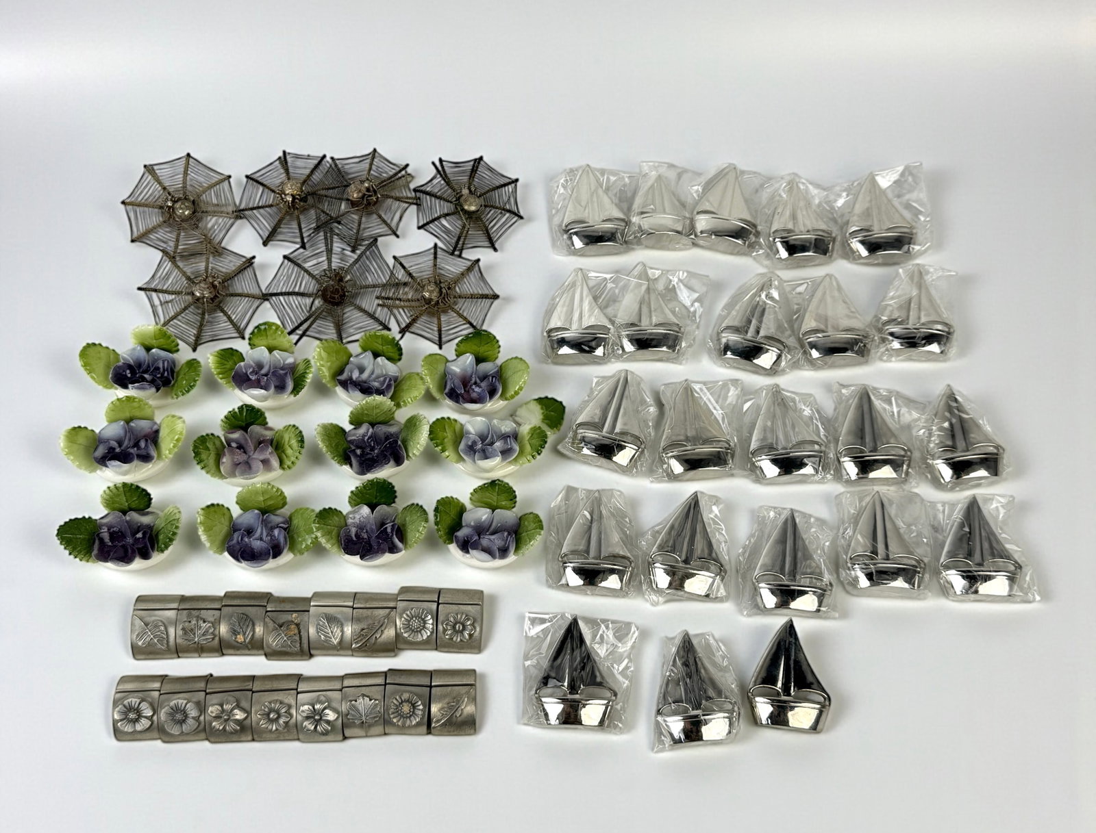 Group Of Place Card Holders: Spiders: 2" Diameter Condition: Mixed condition throughout. One of the flower holders has a broken leaf; the leaf is included. See photos for details. 