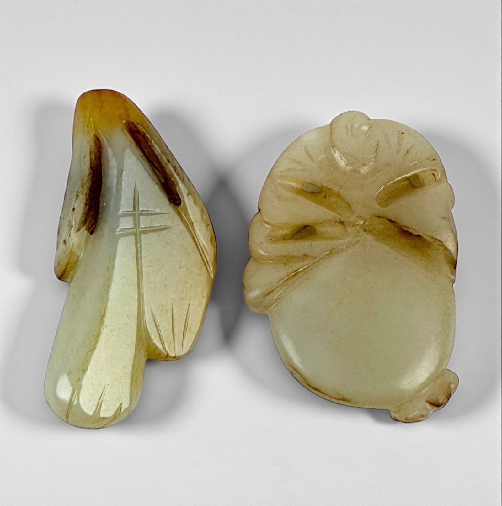 Two Vintage Chinese White Jade Pendants: Dimensions: 1 3/4" Weight: both pieces together 35 grams Condition: Both pieces are in very good condition. Natural discoloration of the jade with some minor signs of aging. 