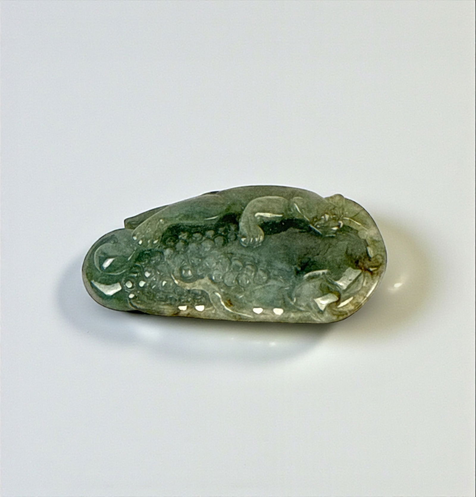 Chinese Jadeite Chilong and Corn Pendant: Dimensions: 2" x 3/4" Weight: 19g Condition: The pendant is in very good condition. Very light surface wear.