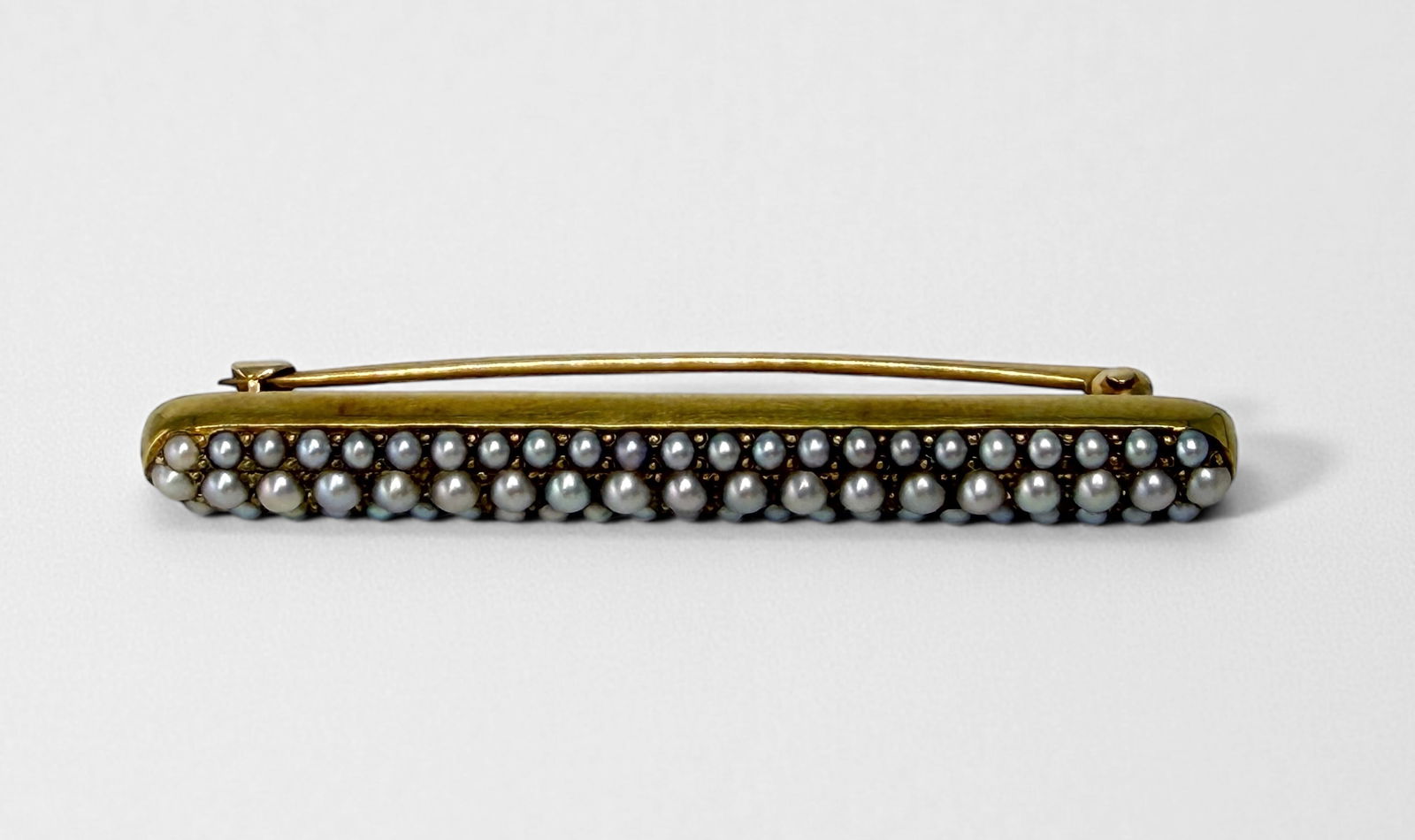 Seed Pearl 14K Brooch: Dimensions: 50.5mm long x 6mm wideWeight: 5.4g Condition: Light surface wear to gold, otherwise in good condition. 
