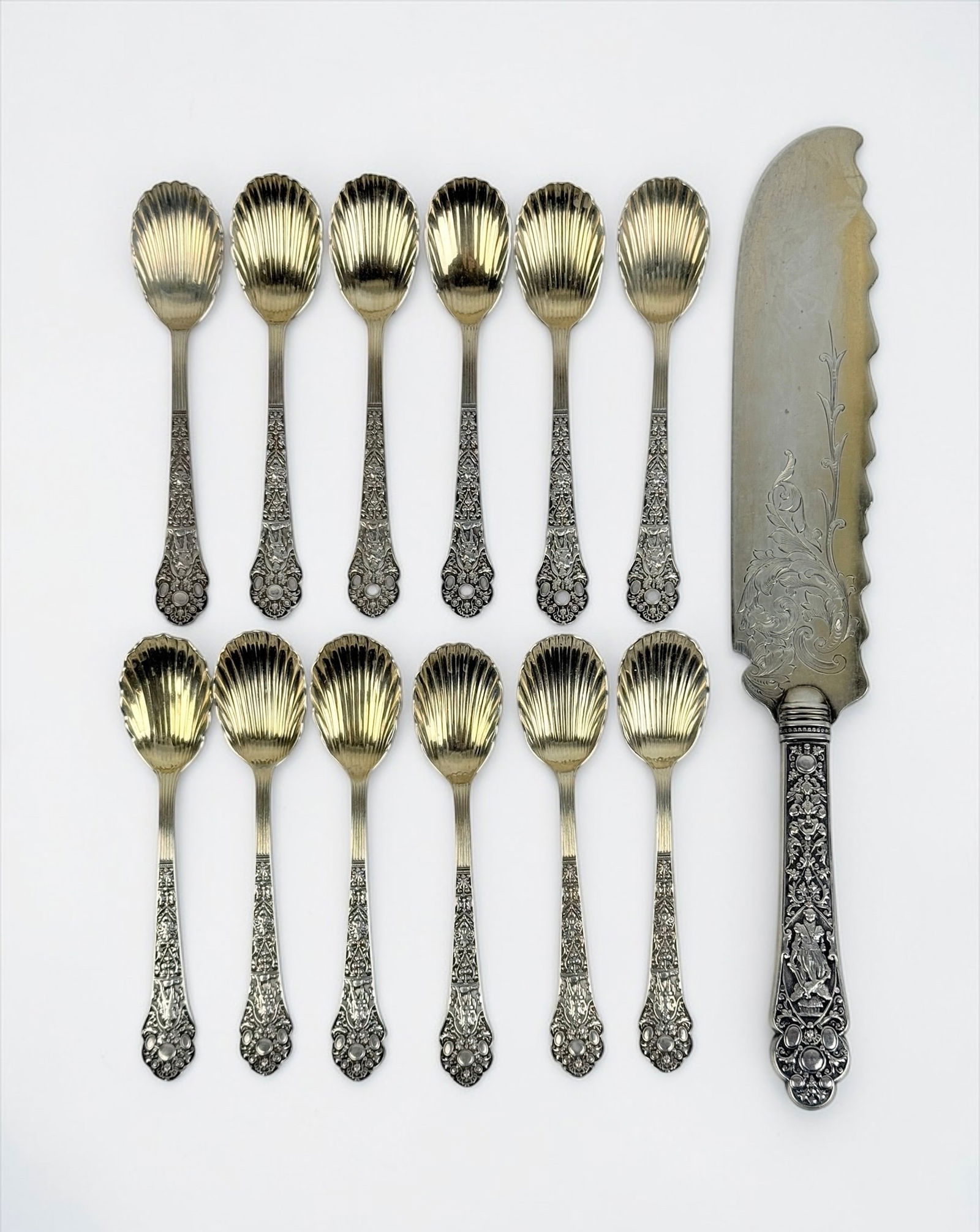 (12pc) Gorham Medici Sterling Shell Flatware: (1) Serving Knife 11" (11) Spoons 5" Total Weight: 10.47ozt Condition: In good condition. See images for details. 