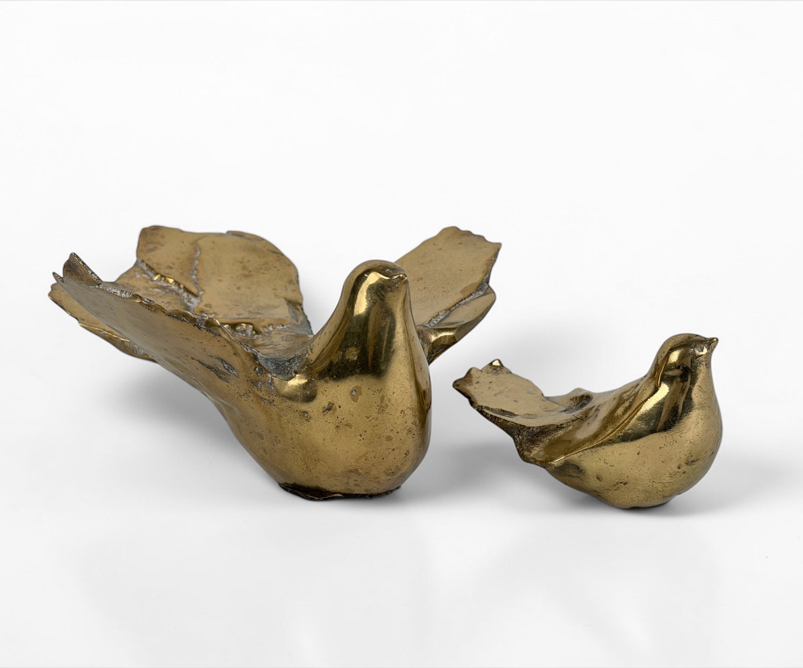 Pair of Eleni Vernadaki Bronze Bird Sculptures: Not marked on bottom. Dimensions: 3 1/2" T x 7" W x 7" D of Largest Condition: Light scratches and marks to the surface; overall, they are in good