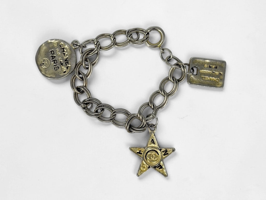 Vintage Chanel Charm Bracelet: Dimensions: 8" Long Condition: Minor wear to the charms. One charm is missing. 