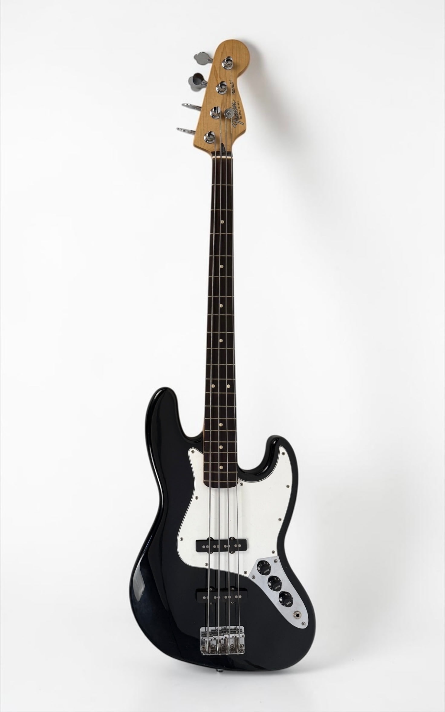Fender Standard Jazz Bass Guitar: Color: Black Serial Number: MN 2107982 Case: Fender Shaped Case Dimensions: Bass: 46" Long Case: 48 1/2" Long Condition: The bass has light scratches and marks to the su