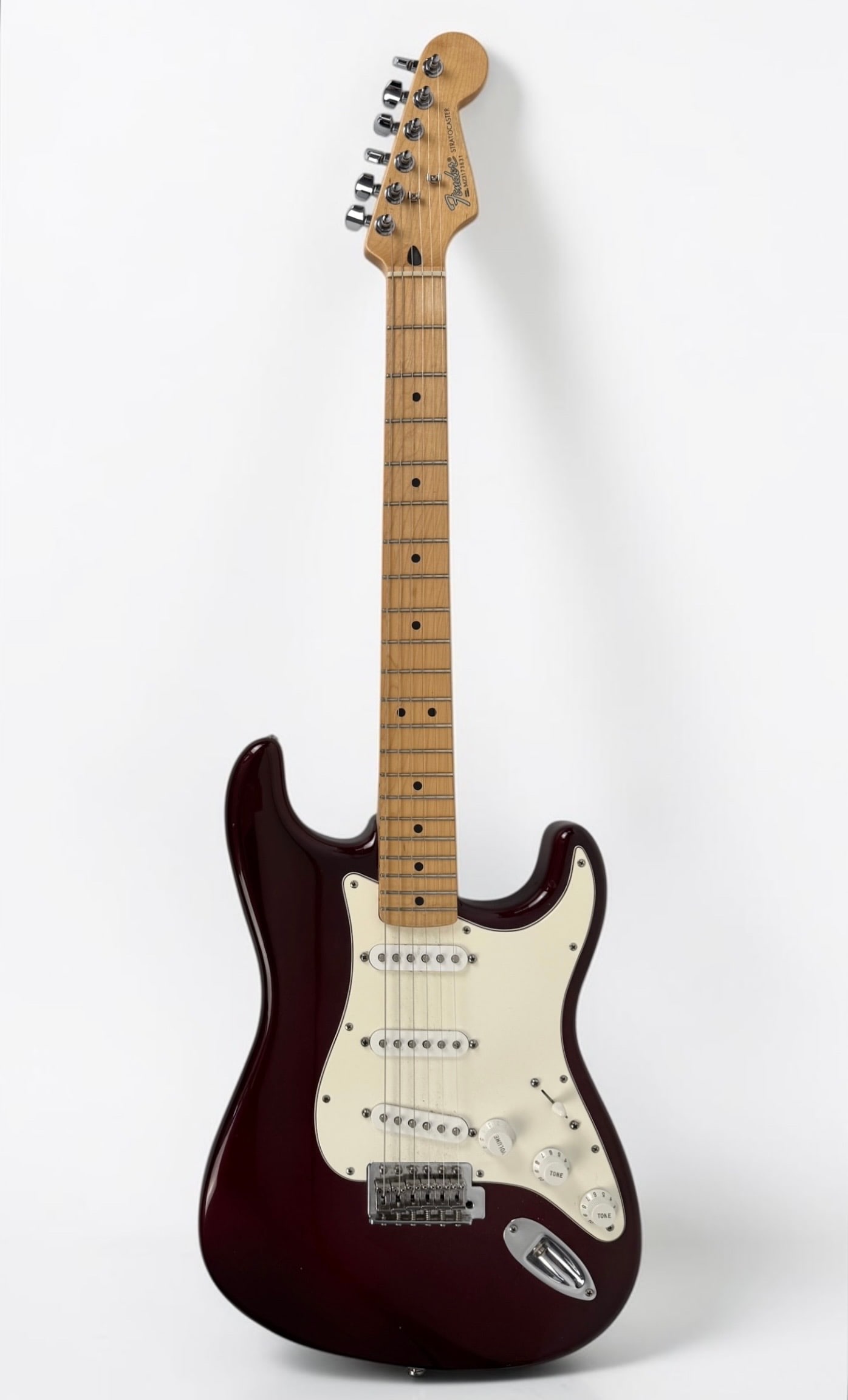 2003 Fender Standard Stratocaster Electric Guitar: Color: Wine Red Serial Number: MZ3173631 Case: Hard Case Dimensions: 38" Long Condition: The guitar is in good condition. 