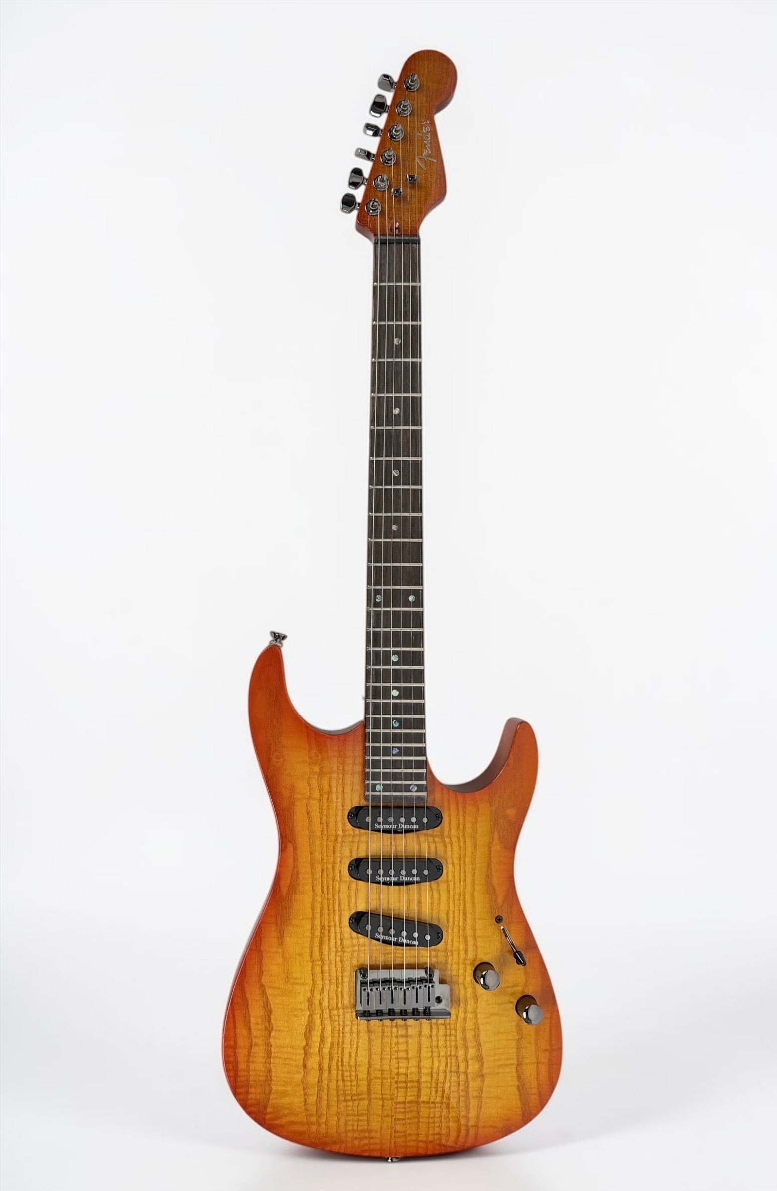 Fender "Showmaster" Flame Ash Top Electric Guitar: Color: Sunburst Serial Number: 04050198 Case: SKB Hard Case Notes: Seymore Duncan pickups, Flame Ash top, Painted Headstock, Smoked Chrome Hardware. Made in Korea. Dimensions: 39&qu