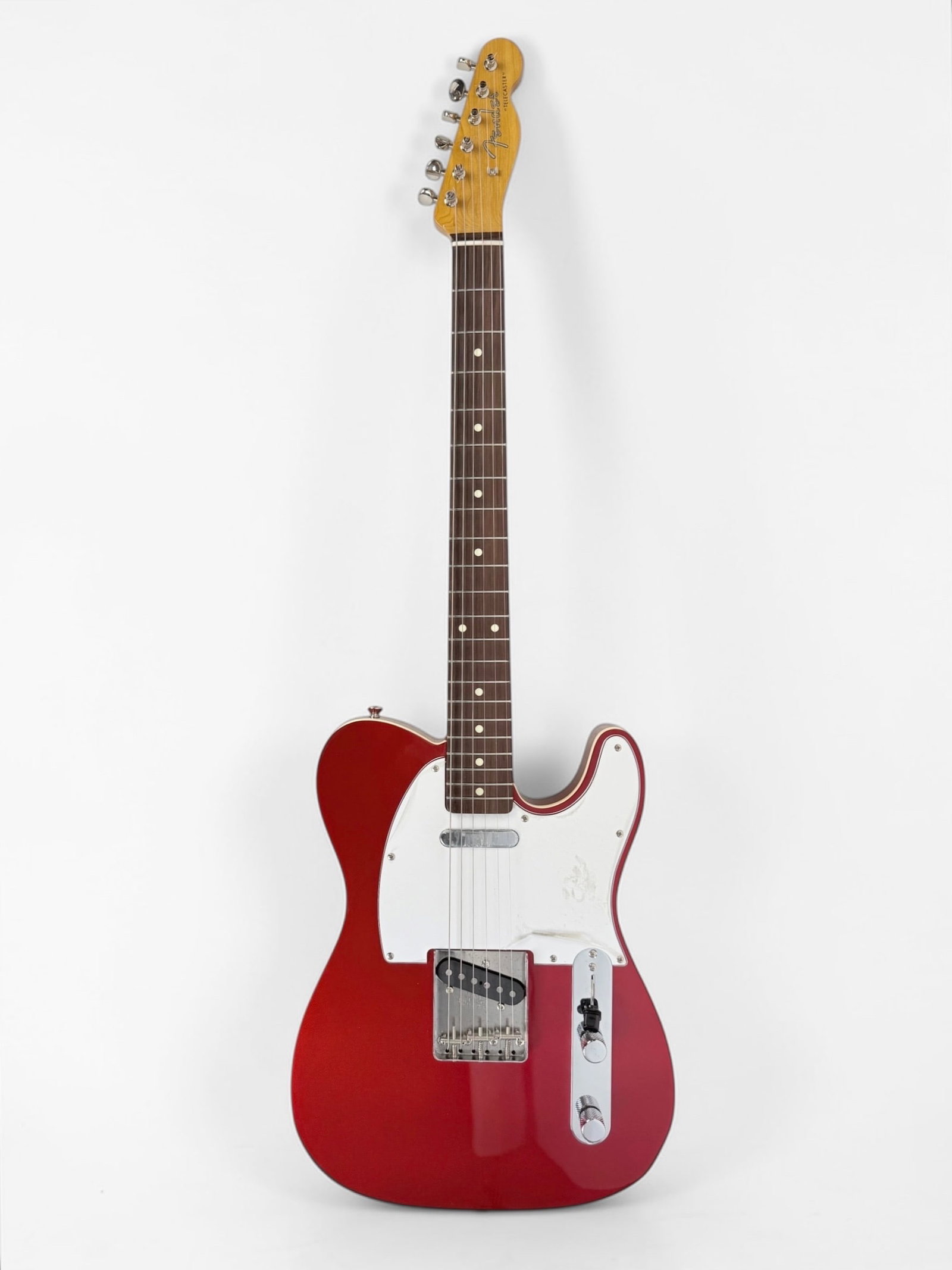 1950s Reissue Fender Red Telecaster Electric Guitar: Color: Red Serial Number: On the chrome bridge plate. Case: Hard Case Notes: Made in Japan, 1950s reissue includes parts for a 1953 model, parts for modern configuration in the case Guitar