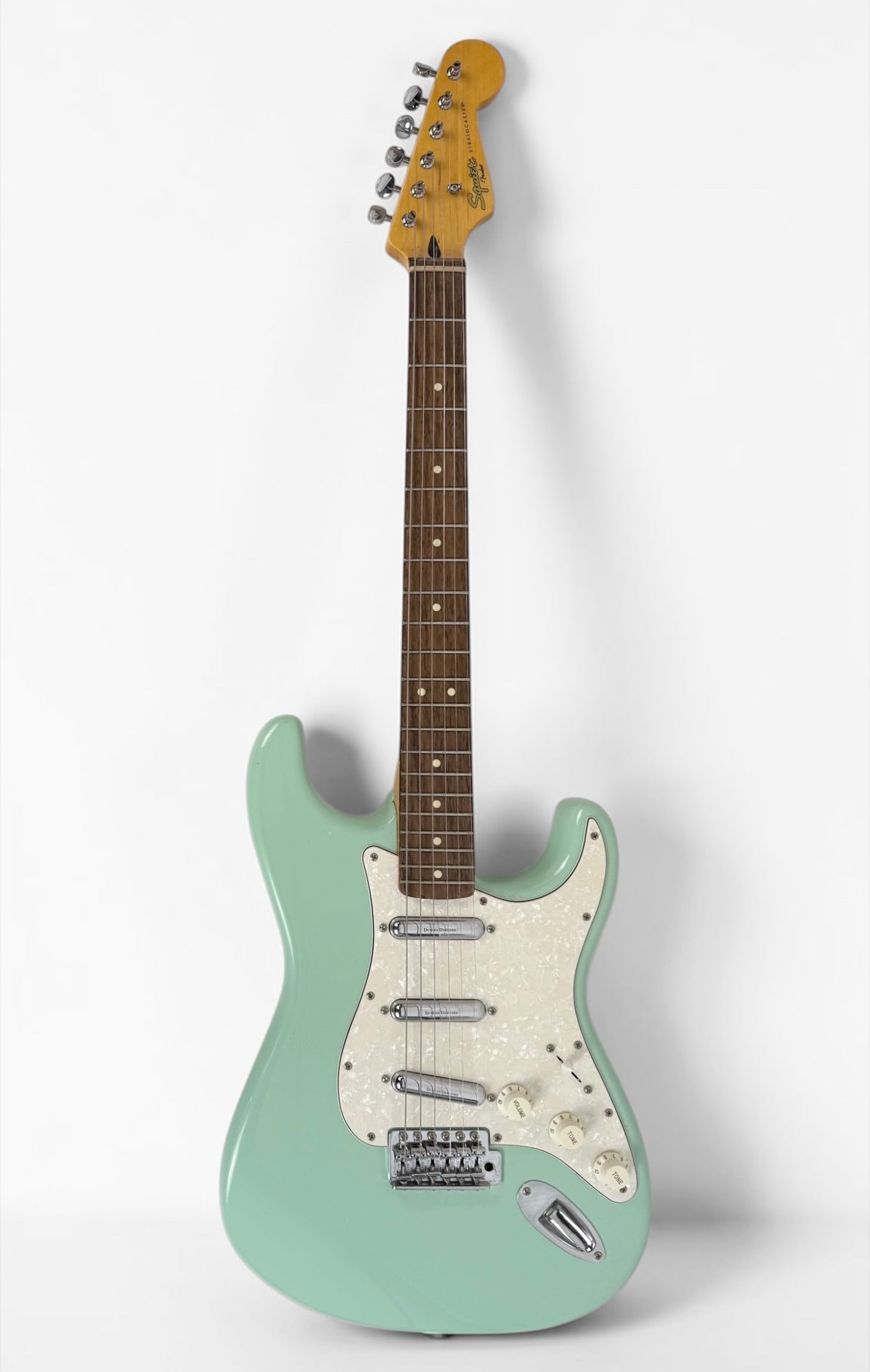 2012 Squier By Fender Stratocaster Electric Guitar: Color: Surf Green Serial Number: ICS12132901 Dimensions: 39" Long Condition: Like-new condition. Includes reverb bar. 