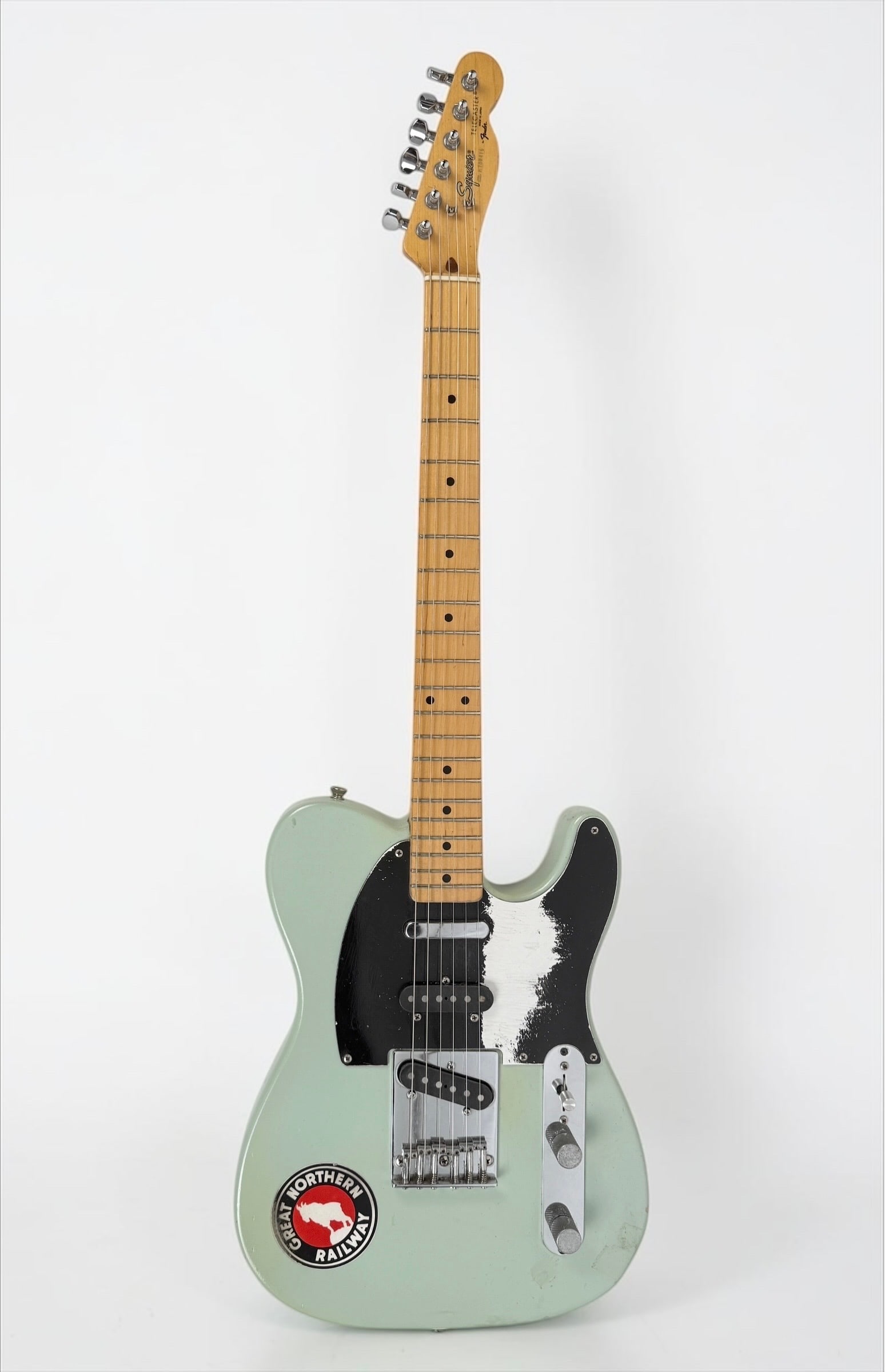 1977 Squier By Fender Telecaster Electric Guitar: Color: Goth Green Serial Number: E708416 Case: Hard Case Year: 1987 Notes: Was repainted Goth Green, has a "Great Northern Railway" deco Dimensions: 38" Long Condit