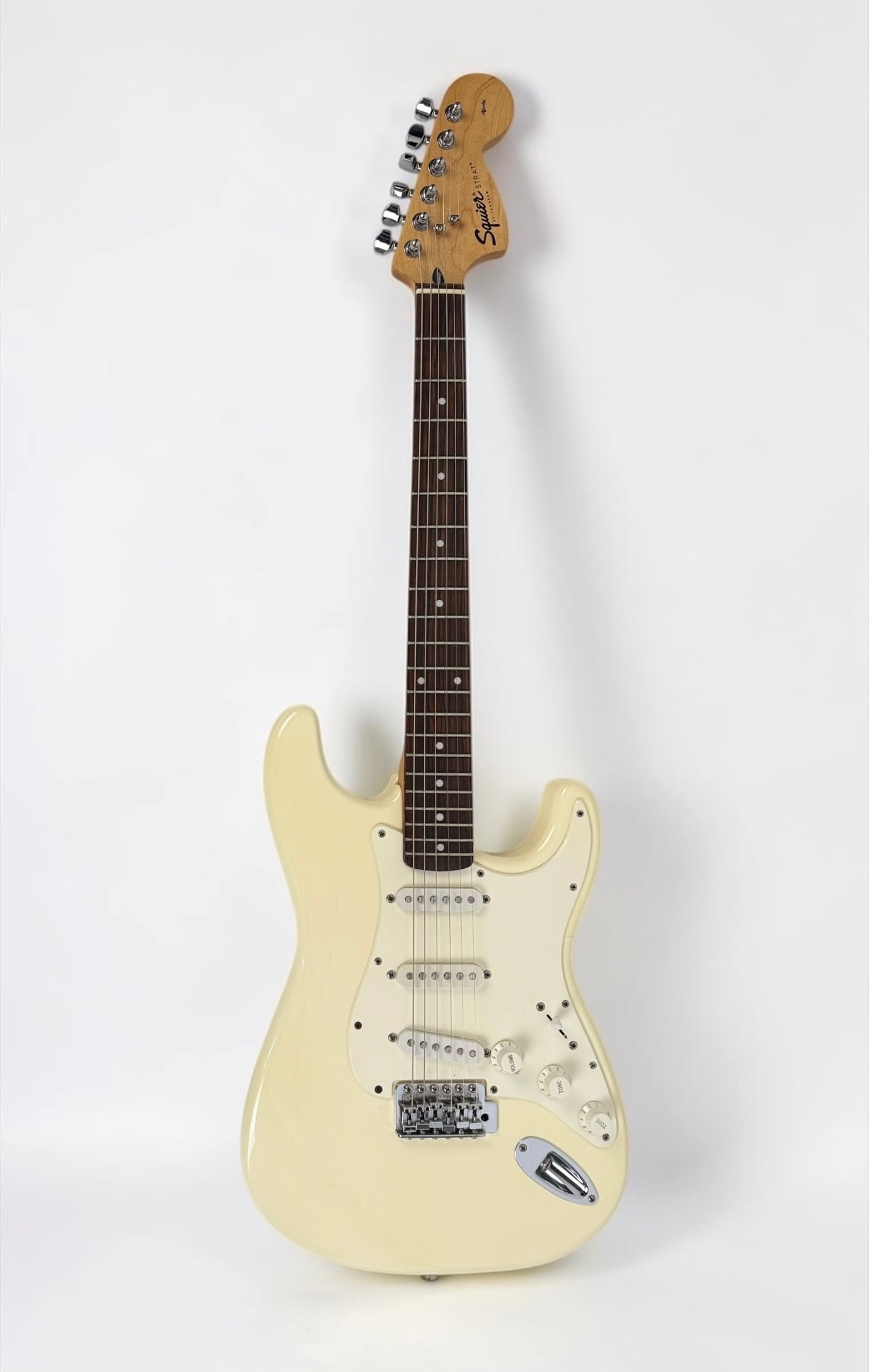 Squier by Fender Stratocaster Electric Guitar: Color: White Serial Number: ICO19800986 Case: Ibenez Hard Case Notes: Narrow but nice neck, easy to play Dimensions: 39" Long Condition: Minor scratches to the pickguard, consistent