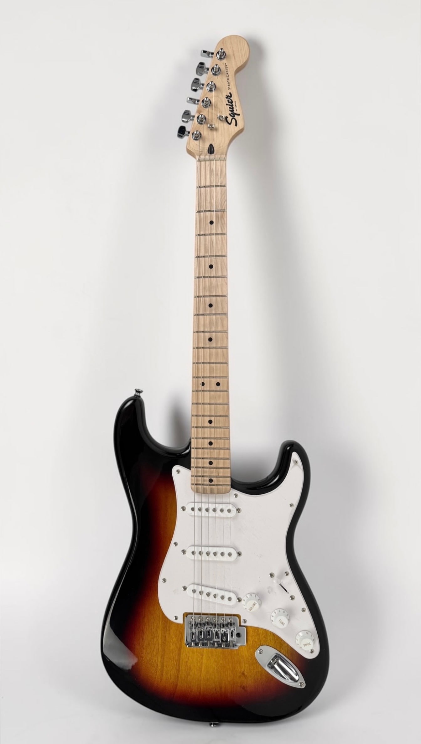 Squier Stratocaster Electric Guitar: Color: Sunburst Serial Number: ICSI21031685 Case: Soft case Dimensions: 38" Long Condition: Surface marks to the body. The protective plastic is still on the pickguard.&