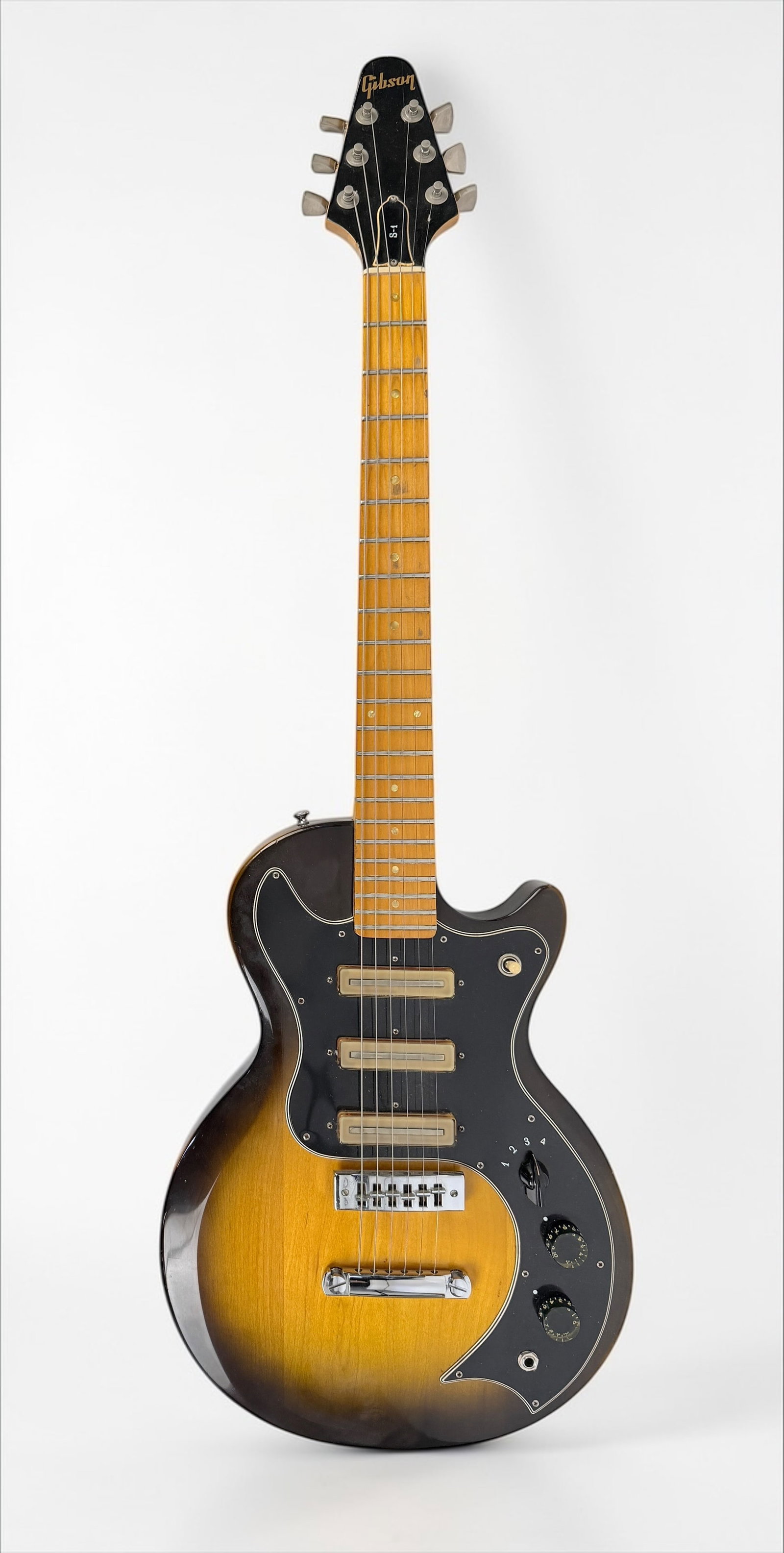 1977 Vintage Gibson S1 Electric Guitar: Color: Vintage Sunburst Body: Solid body construction with a bolt-on maple neck. Hardware: Equipped with a tune-o-matic bridge and stopbar tailpiece. Electronics: Designed by Bill La