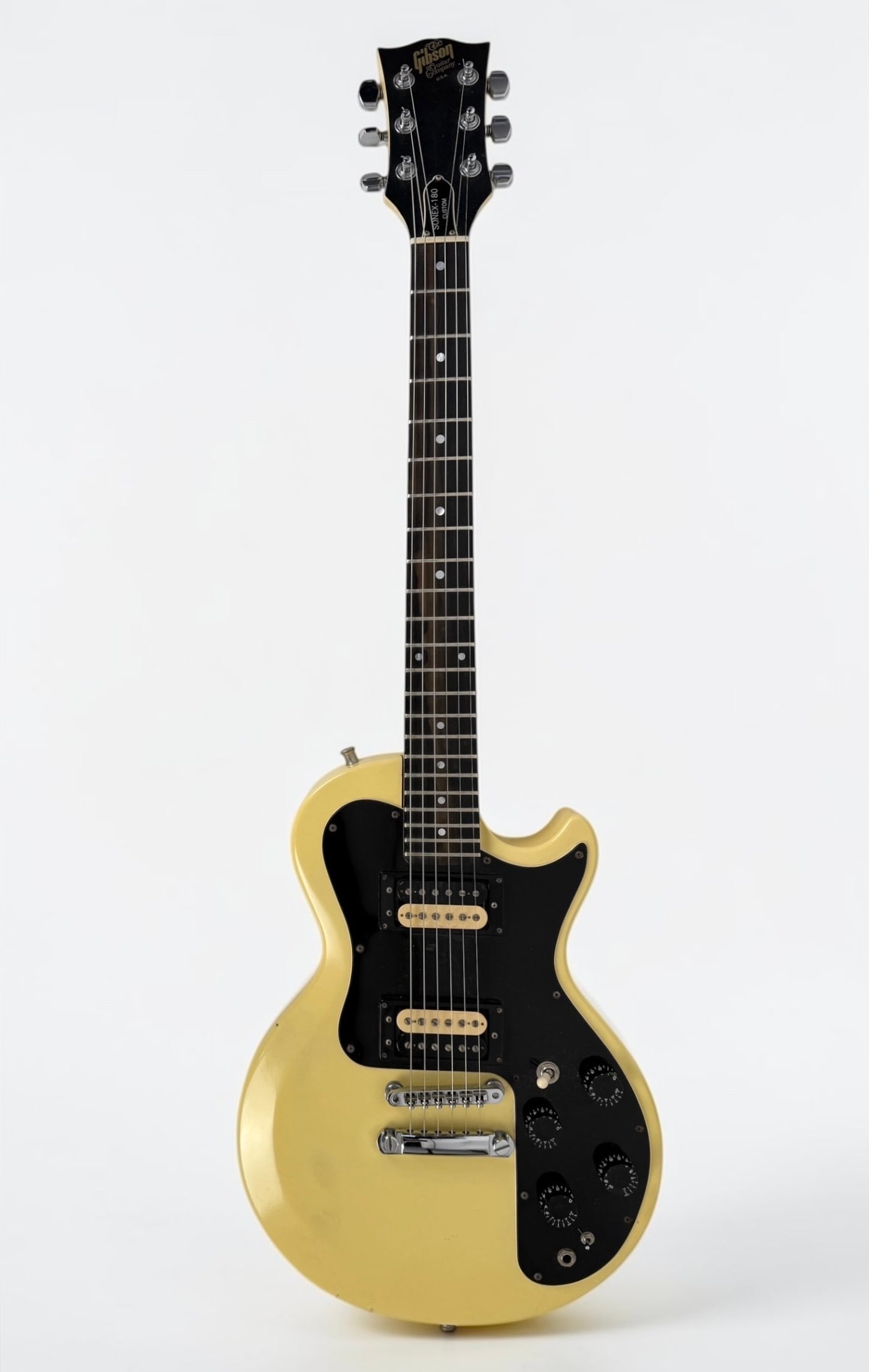 1984 Gibson Sonex-180 Electric Guitar: Color: Custom White Composite Body Serial Number: 82040601 Case: 1970s Factory Case Dimensions: 39" Long Condition: The guitar is in good vintage condition with some surface m