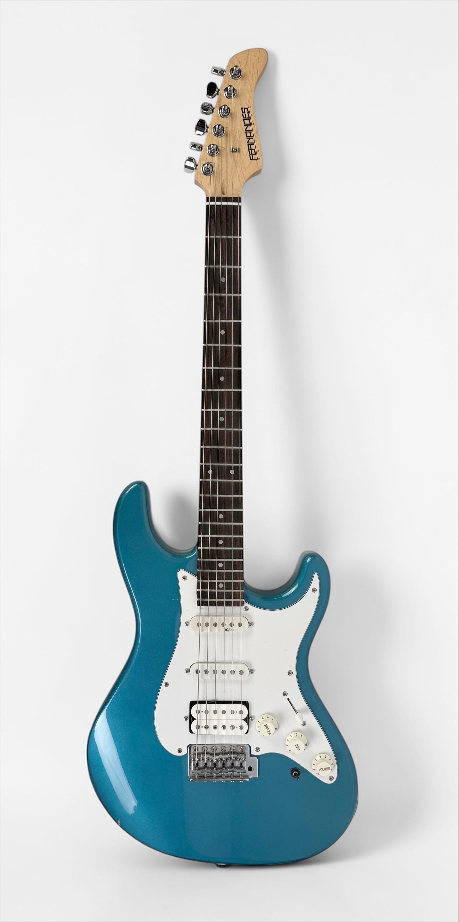 2000s Fernandes Strat Style Guitar: Color: Sonic Blue Serial Number: 103213 Case: Kramer Hard Case Dimensions: 38 1/2" Long Condition: The guitar is in good condition with light wear to the pickguard consistent 