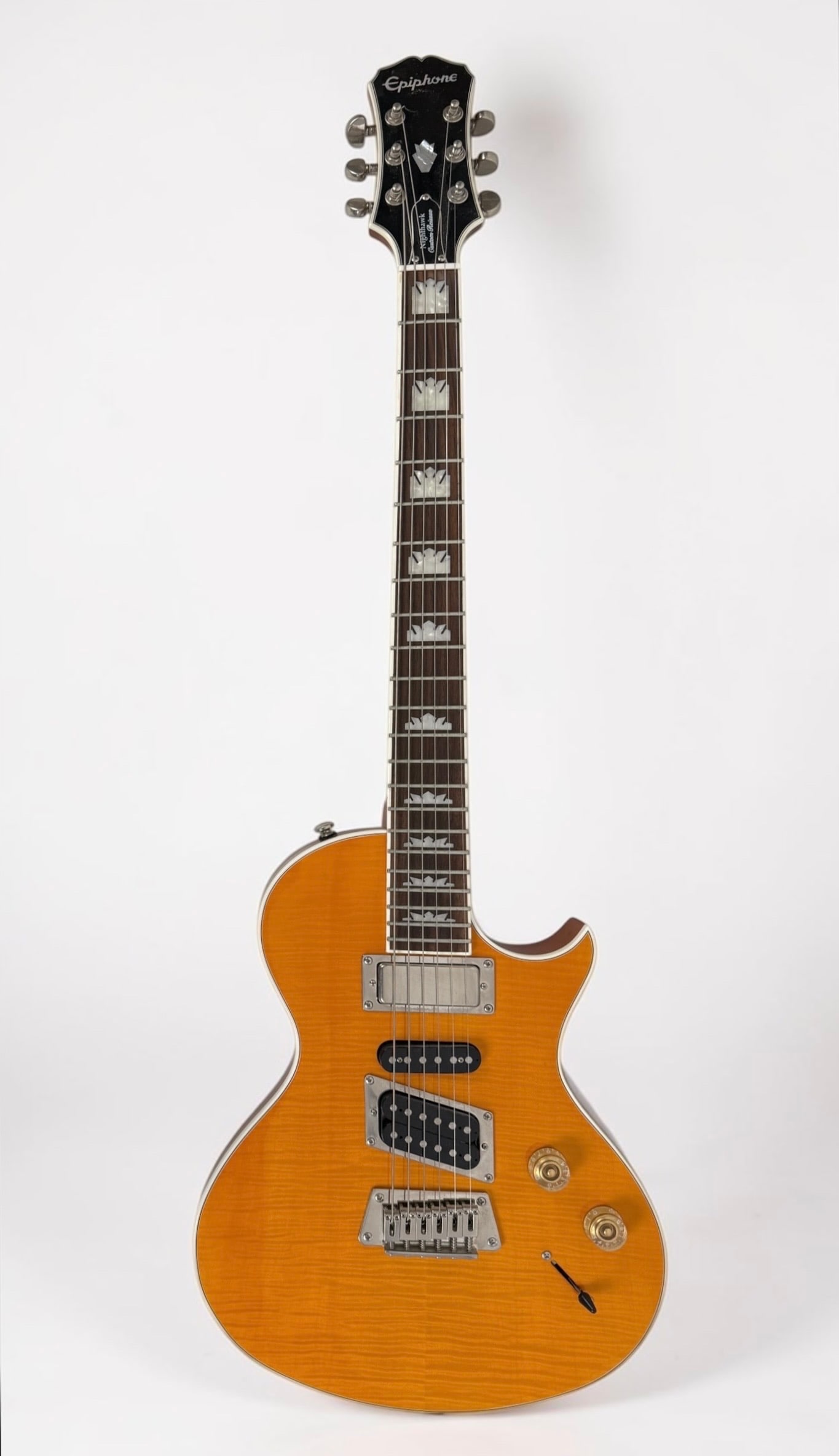2010s Epiphone Nighthawk Custom Reissue Electric Guitar: Color: Transparent Amber Serial Number: 11032308771 Dimensions: 39" Long Condition: The guitar is in very good condition. 