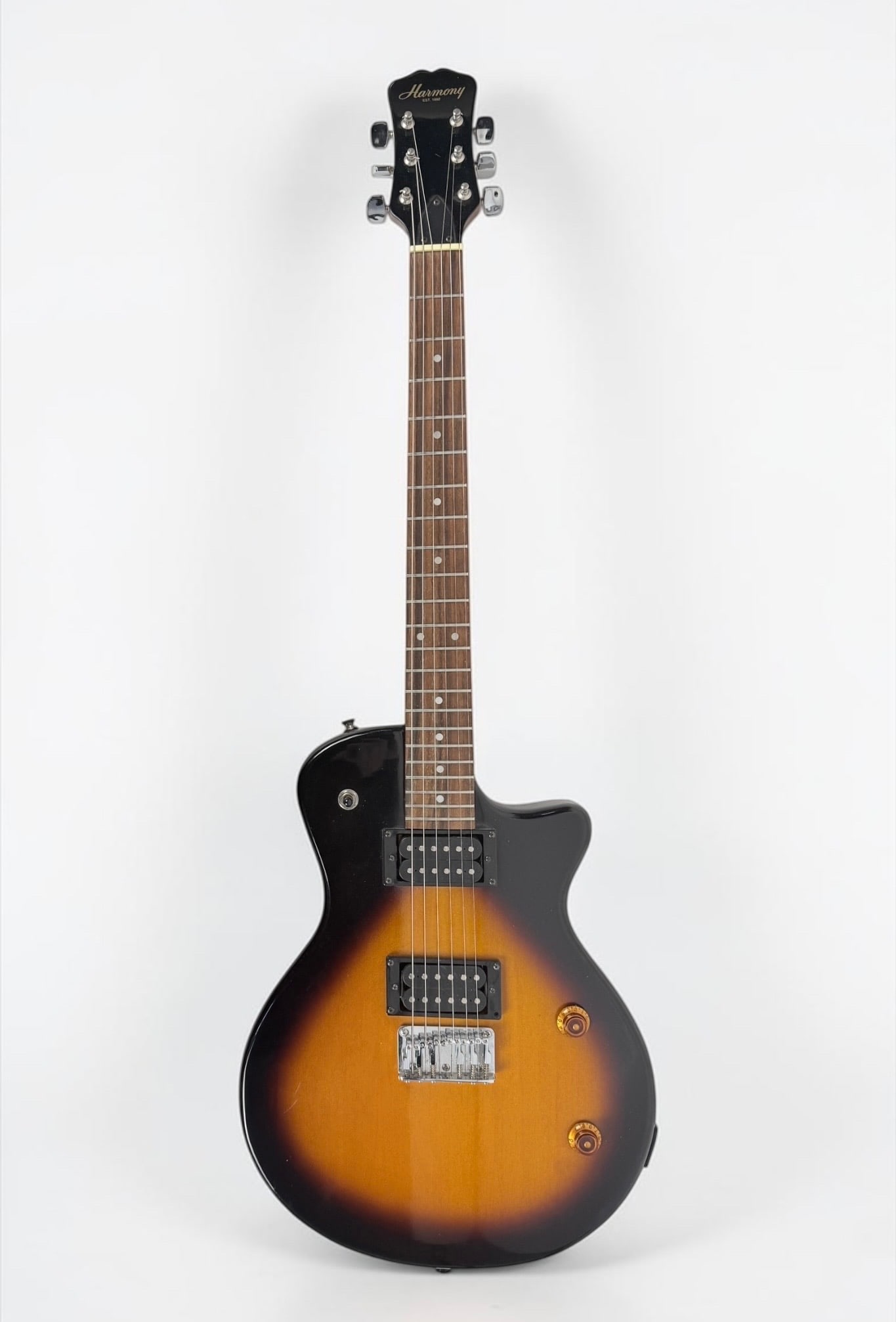 Harmony Les Paul Jr. Stratocaster Electric Guitar: Color: Sunburst Serial Number: 02831 Case: Gibson MIII Case Dimensions: Guitar: 39" Long Case: 42 1/2" Long Condition: The guitar has surface wear throughout. The case h
