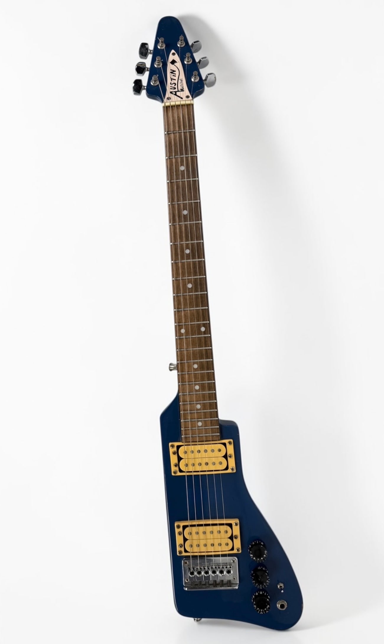 Vintage Austin Hatchet Travel Guitar: Color: Blue Serial Number: N/A Case: Soft gig bag Dimensions: 35" Long Condition: Wear throughout the body, consistent with use. 