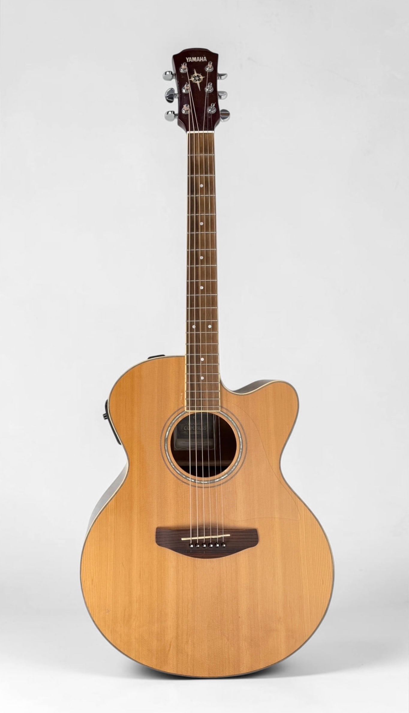 2009 Yamaha Compass CPX Acoustic/Electric Guitar: Color: Natural Serial Number: QPM 036287 Case: Hard Case Dimensions: 41" Long Condition: Surface scratches and marks, consistent with gentle use. The case has surface marks