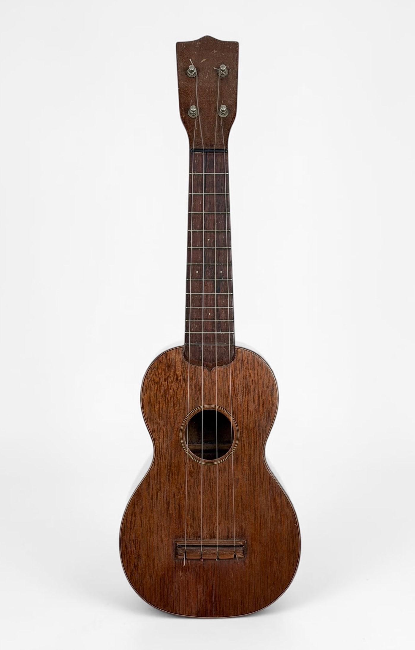 Vintage CF Martin Co Soprano Ukulele: Materials: Mahogany and Rosewood Serial Number: 1838 Dimensions: 21" Long Condition: There is a small crack to the front of the ukulele and one along the back. All tuning