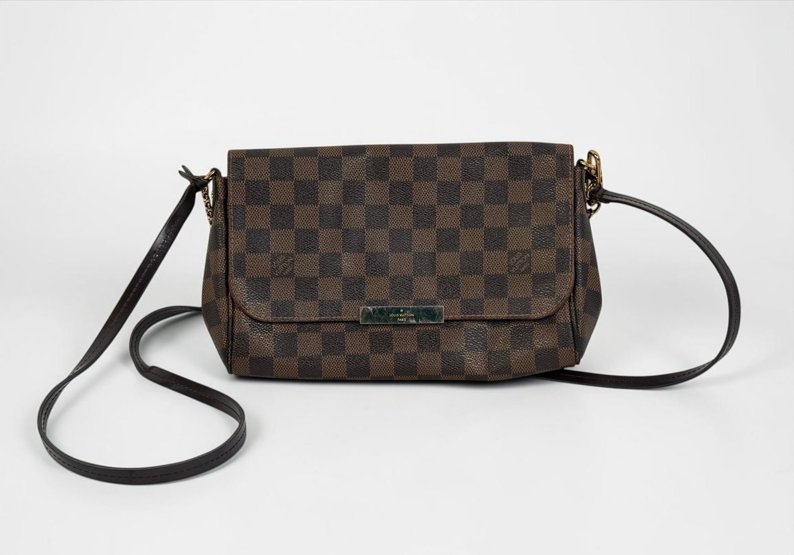 Louis Vuitton Damier Ebene Favorite MM Bag: From the 2015 Collection by Nicolas Ghesquiere. Canvas interior with a single pocket and brass hardware. Dimensions: 6 1/2" x 9 1/2" x 2" Shoulder Strap: 44&quo