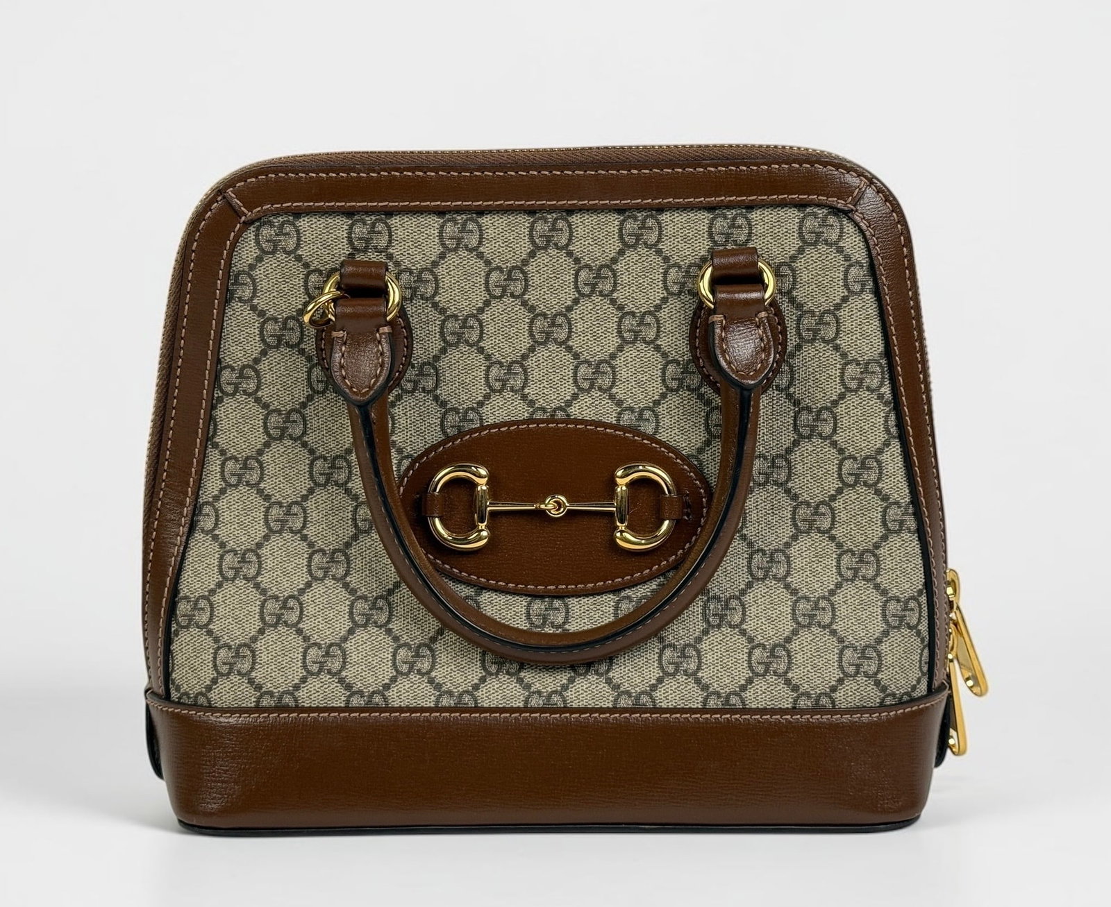 Gucci 1955 Horsebit Small Top Handle Bag: Comes with a crossbody strap and original dust bag. Gold-tone hardware with leather trim. Protective feet on the bottom. Two interior pockets. Dimensions: 9" x 10