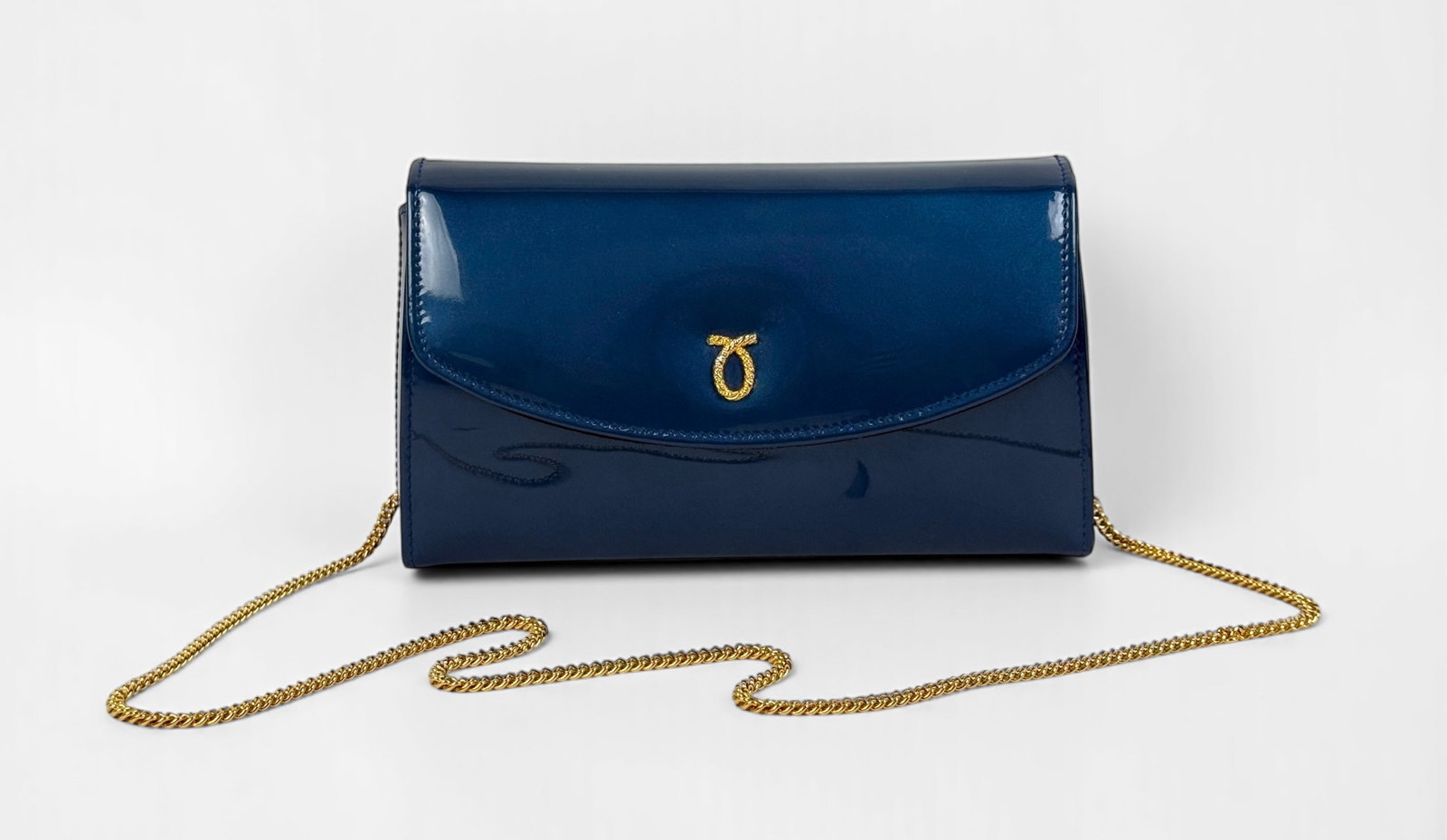 Launer London High Society Clutch in Royal Blue: Comes in original box with dust bag. The strap is removable. Dimensions: 9" x 5 1/4" x 2 3/4" Condition: Light marks to the surface; otherwise, the bag