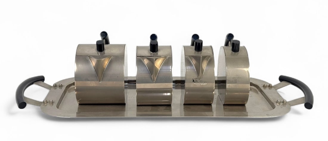 Massimo Podesta For Montagnani Tea Set With Tray: Stainless steel with black handles Tray: 18 3/4" × 8 3/4"Largest Pot: 3 3/4"H × 5"L × 3"D Condition: Light scratches and surface wear with