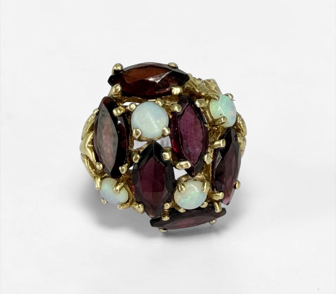 14K Gold Opal & Garnet Ladies Cocktail Ring: Size: 6 1/2 Weight: 9.09g Dimensions: 1" x 1" setting Condition: Light surface scratches; otherwise, the ring is in good condition. 