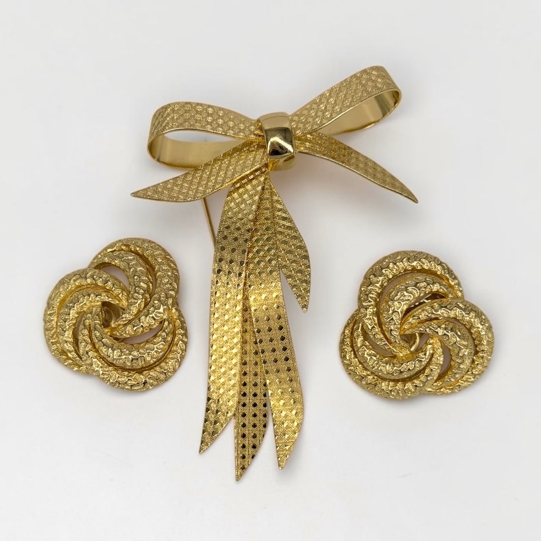 Christian Dior Earrings and Brooch: Total Weight: 51.11g Brooch: 3 1/2" x 2 1/2" Earrings: 1 1/2" Diameter Condition: Both the earrings and brooch are in good condition. The earrings are clip-on style. 