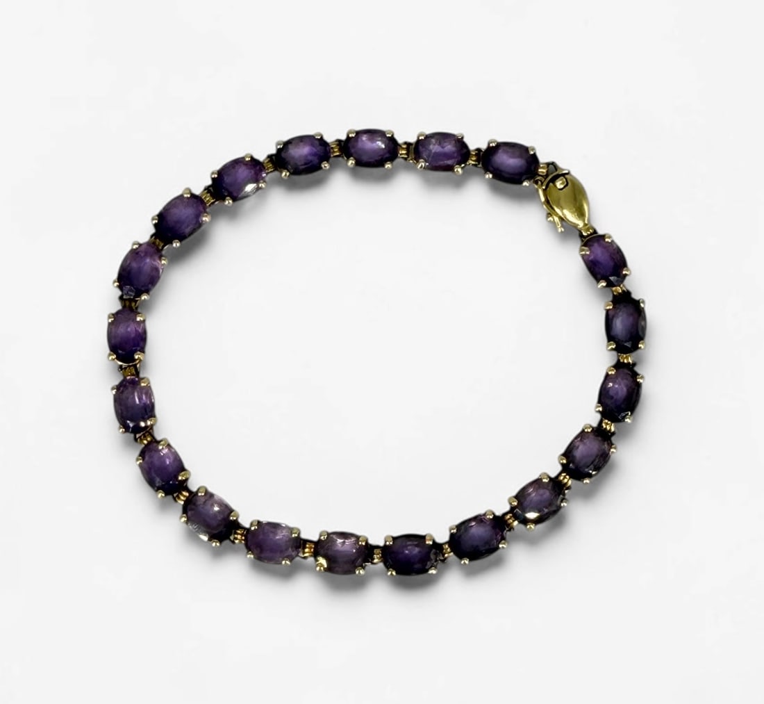 10K Gold Amethyst Tennis Bracelet: Size: 7" Weight: 6.7g Amethyst: Each approximately 6.8mm x 5mm Condition: Good