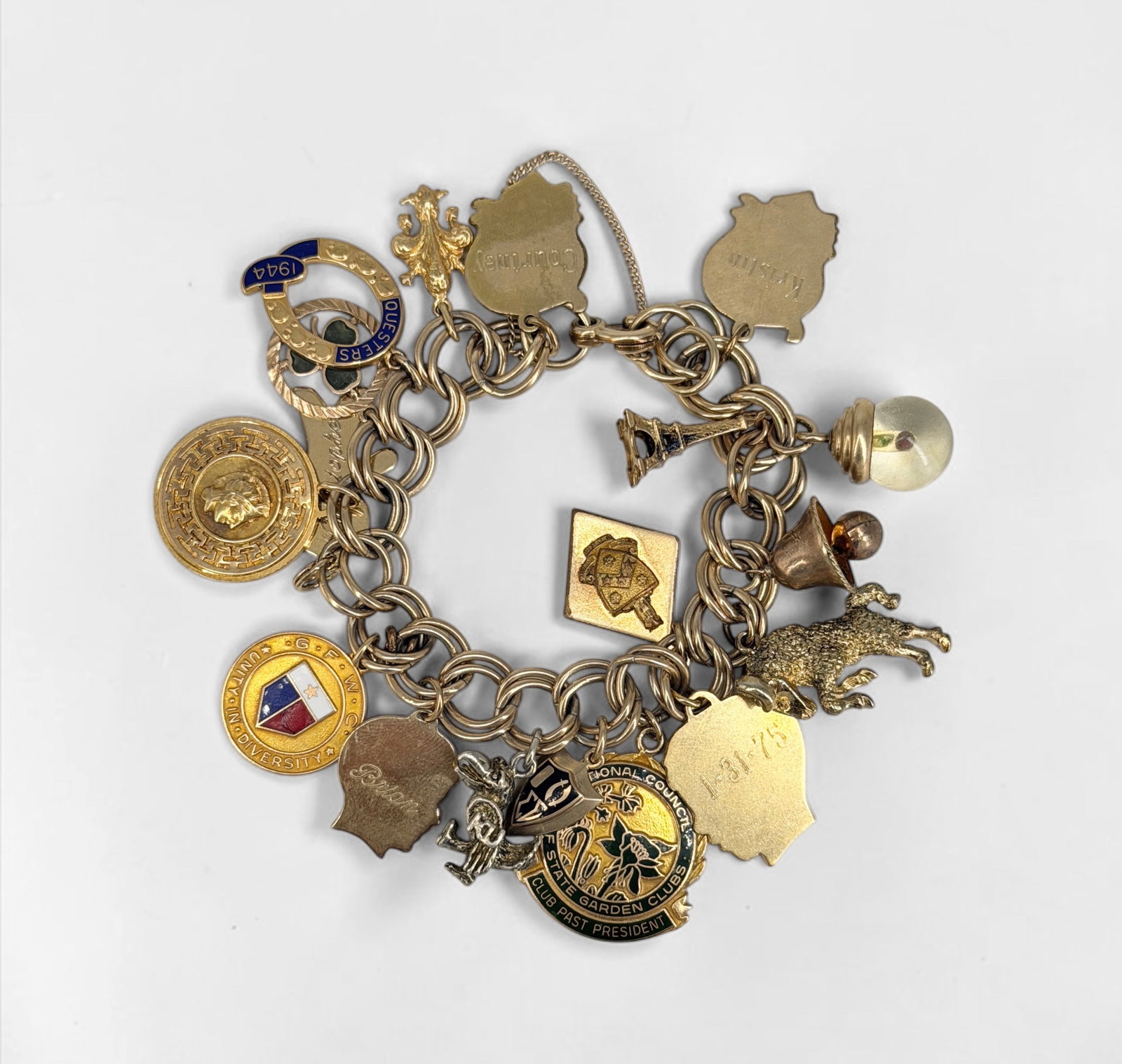 Gold Filled & 10K Gold Charm Bracelet: The bracelet is gold-filled with a few 10K gold charms. Total Weight: 69.21g Dimensions: ~7 1/2" long when clasped, charms are ~1" Condition: In good condition.&nbs