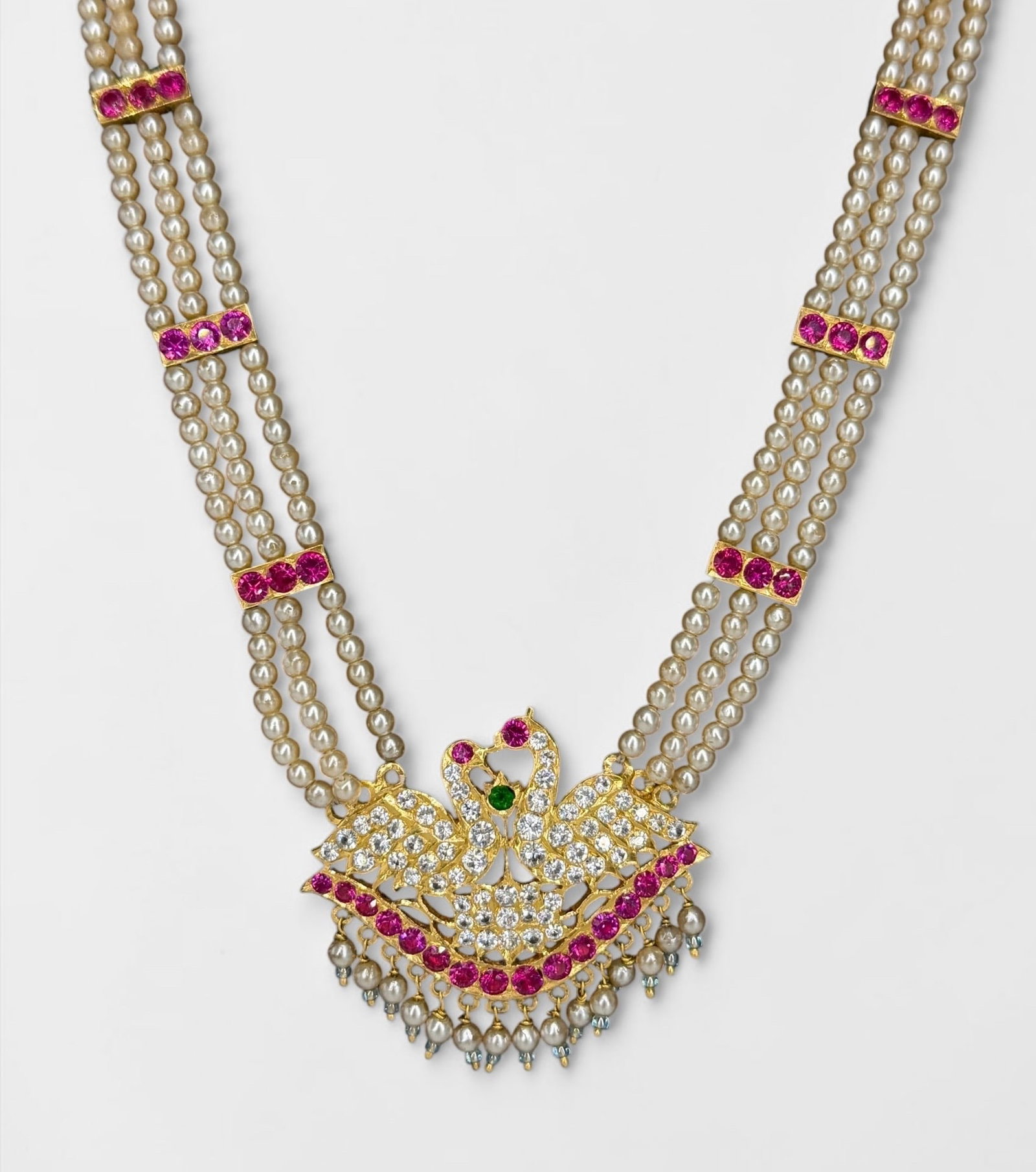 Indian High Karat Gold, Red & White Stone Pearl Necklace: Total Weight: 44.38g Pendant Weight: ~25g Length: 28" Long Dimensions: 1 1/2" x 2" Pendant Condition. Fraying to the green tassel, but in overall good cond