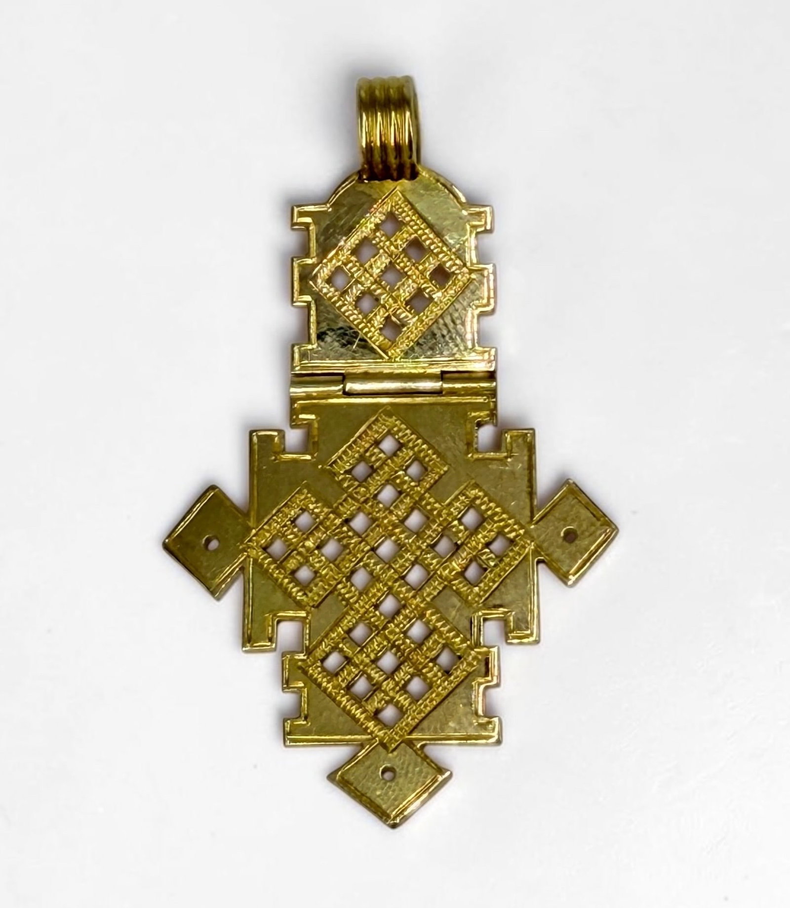 High Karat Yellow Gold Ethiopian Axum Cross Pendant: Tests at 22K or better Length: 2" (including bale) Weight: 9.4g Condition: Very Good