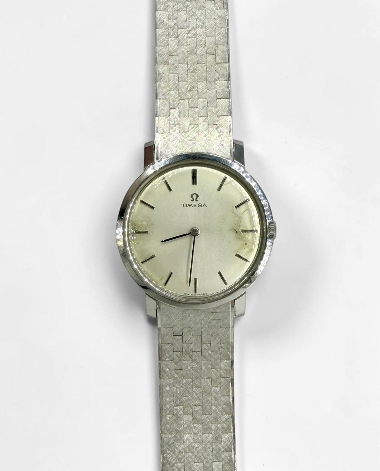 18K White Gold Omega Wrist Watch: Weight: 50.12 Dimensions: 7 1/2" Band, 32mm face. Condition: Wear to the face and band. Engraved on verso. Needs a new battery. Not tested for time keeping. 